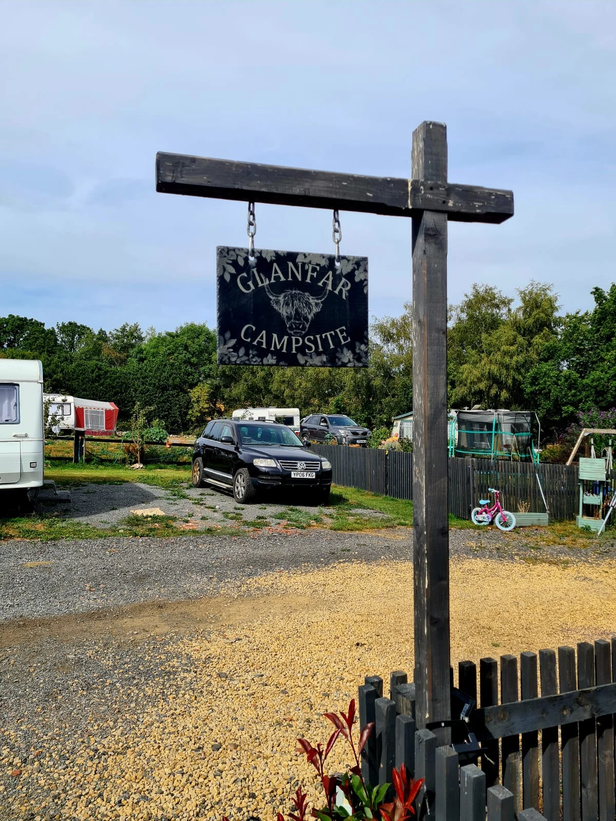 Rustic Glanfar campsite sign at the entrance