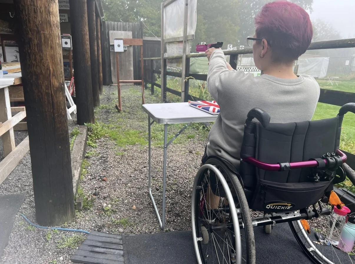 A seated participant taking part in a supervised Target Sport shooting session