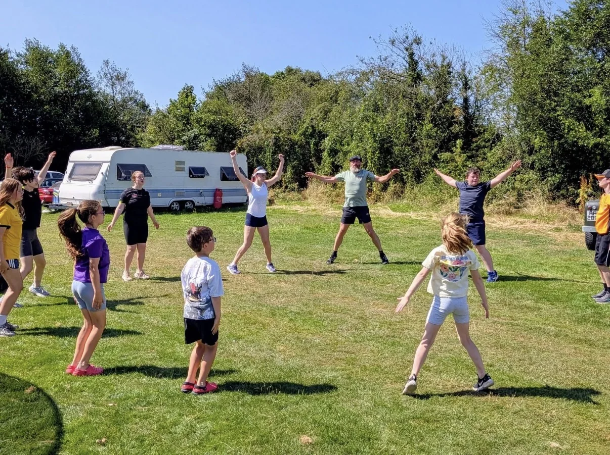 A Target Sport group warming up together outdoors