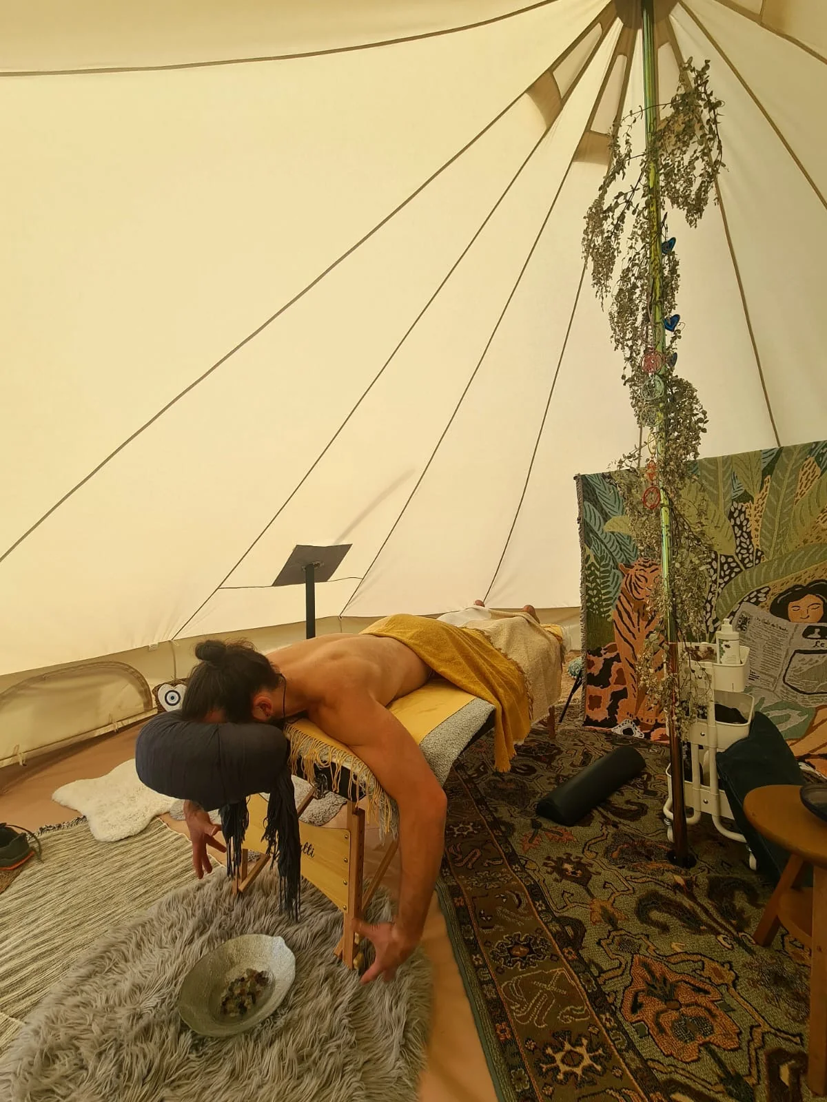 A HeartWork massage treatment inside the bell tent